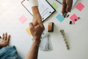Two men shaking hands after coming to a financial agreement